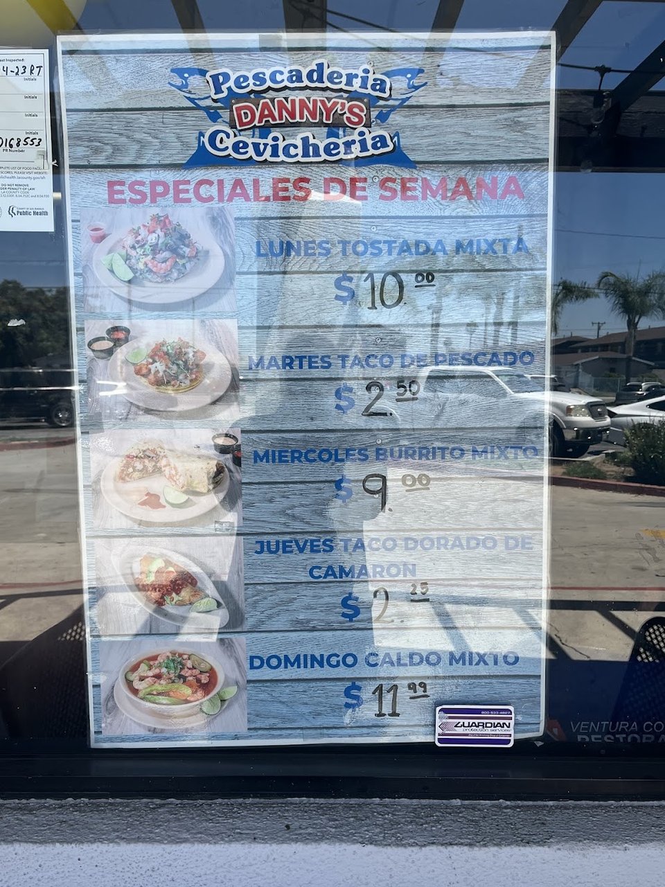 Printed menu showing fish tacos and ceviche.